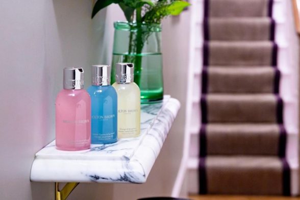 a collection of molton brown poducts near stairs