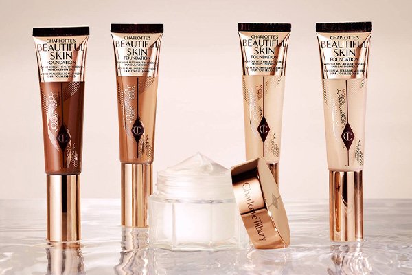 a collection of 4 different shades of charlotte tilburys beautiful skin foundation and a magic cream