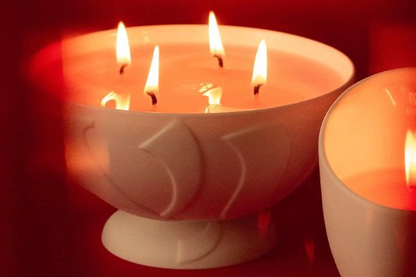 a large vyrao candle lit against a red background