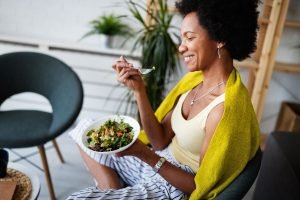 Woman eating a bowl of healthy food 