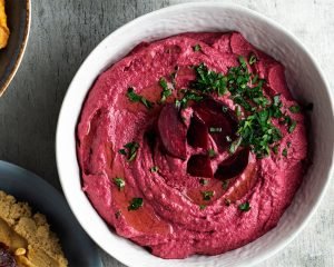 A bowl with beetroot hummus. 