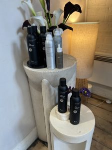 A display of Living Proof hairsprays at an event for LOOKFANTASTIC