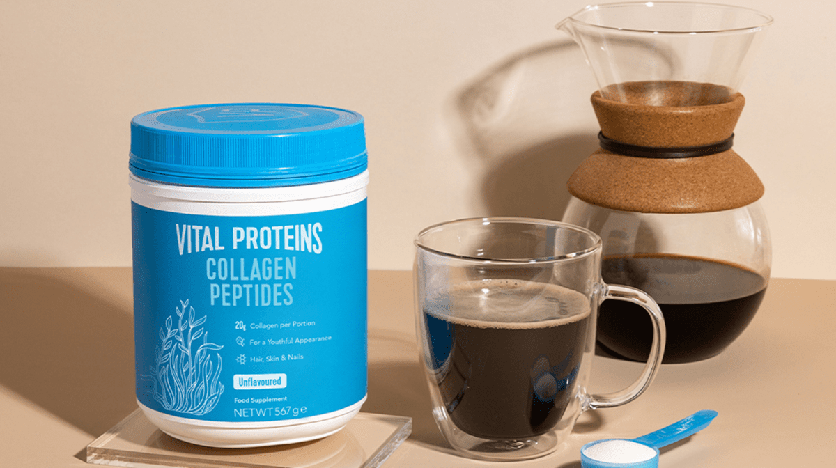 vital proteins collagen peptide powder with a scoop and coffee
