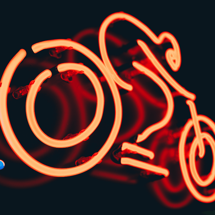 a neon sign of a man on a bike