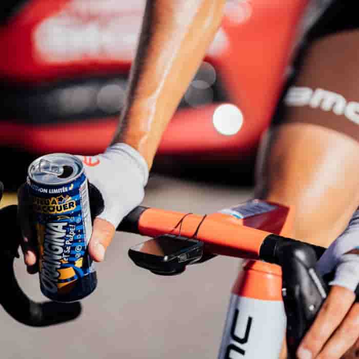 A cyclist with a can of drink