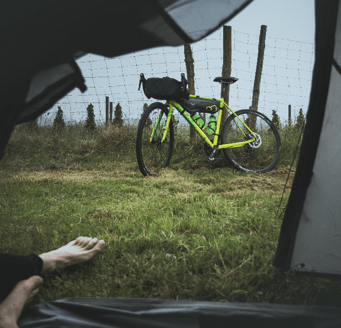 a view from a tent looking at a bike