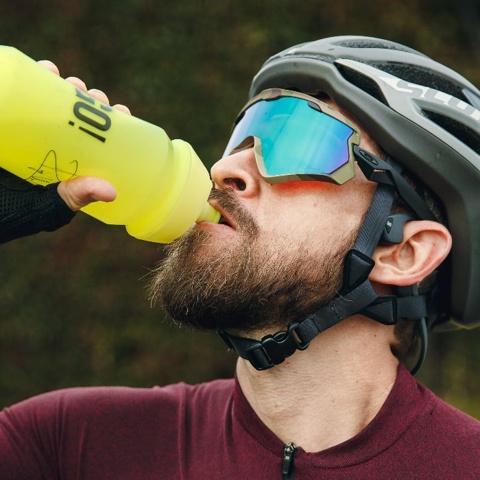 A cyclist drinking from a bottle