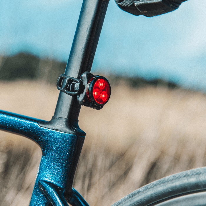 A rear bike light on a seat post