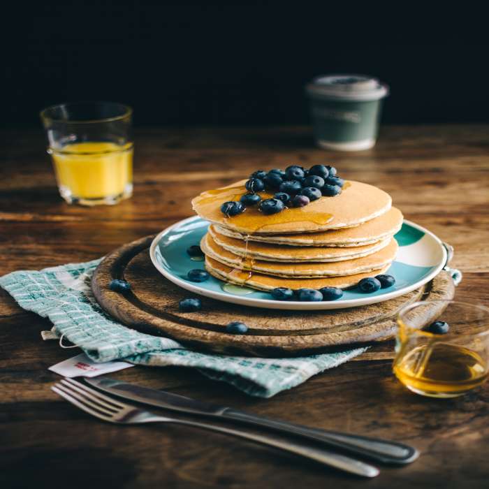 A stack of pancakes with blueberries on top