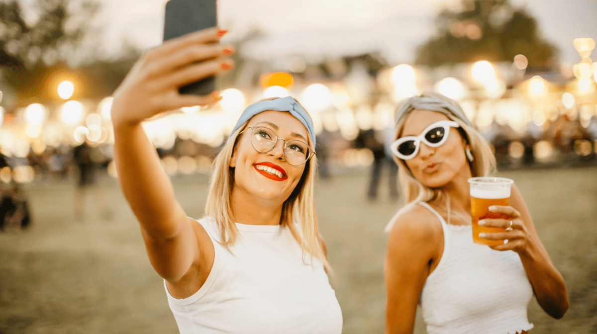 Two women taking a selfie at a festival