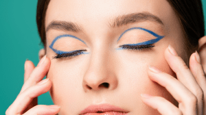 Woman sporting a blue graphic eyeliner look