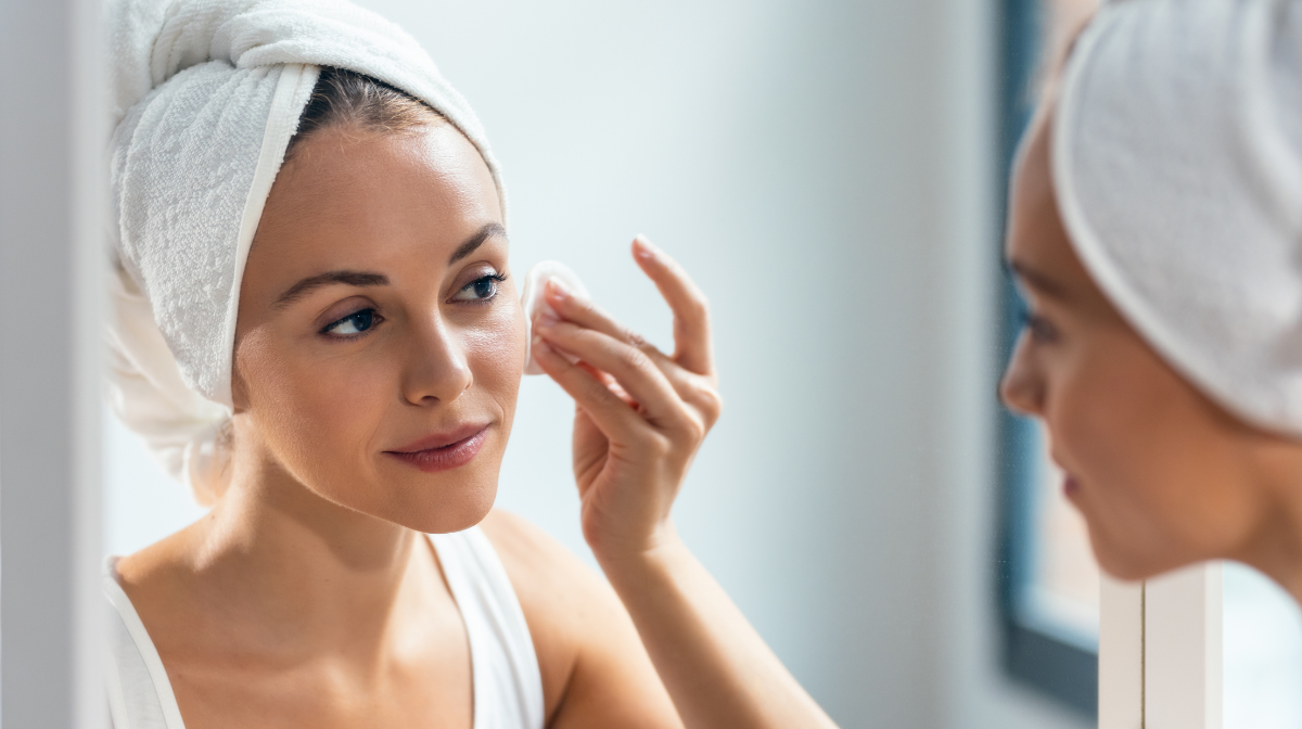 Woman removing her makeup with a cloth.