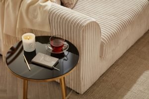 candle and notebook on side table