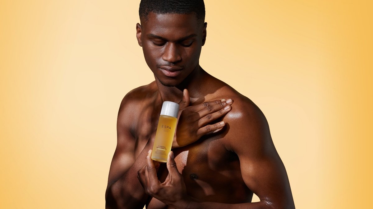 man massaging body oil