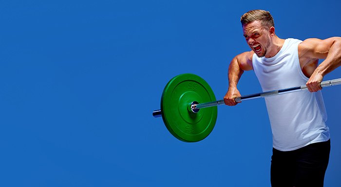 man lifting heavy weights on barbell