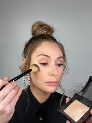 Makeup artist applying highlighter