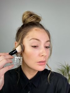 makeup artist applying contour stick