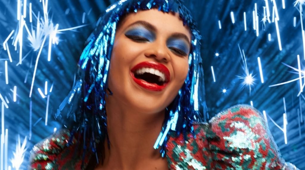 Model wearing tinsel wig and blue eyeshadow