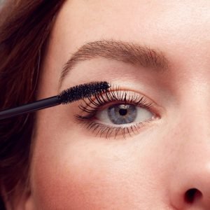 woman applying mascara