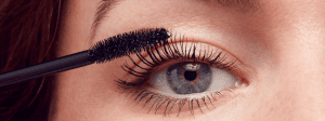 woman applying mascara