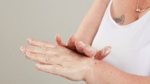 woman using hand cream