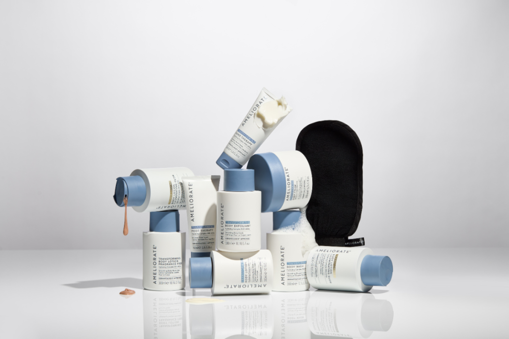 AMELIORATE skincare range with body lotions, exfoliants, and mitt on white background