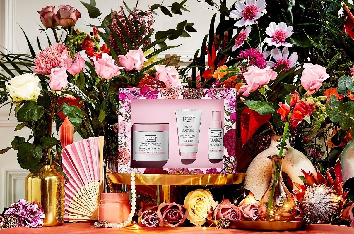 Christophe Robins hair care christmas gift sets for flat hair, containing three volumising products surrounded by pink flowers.
