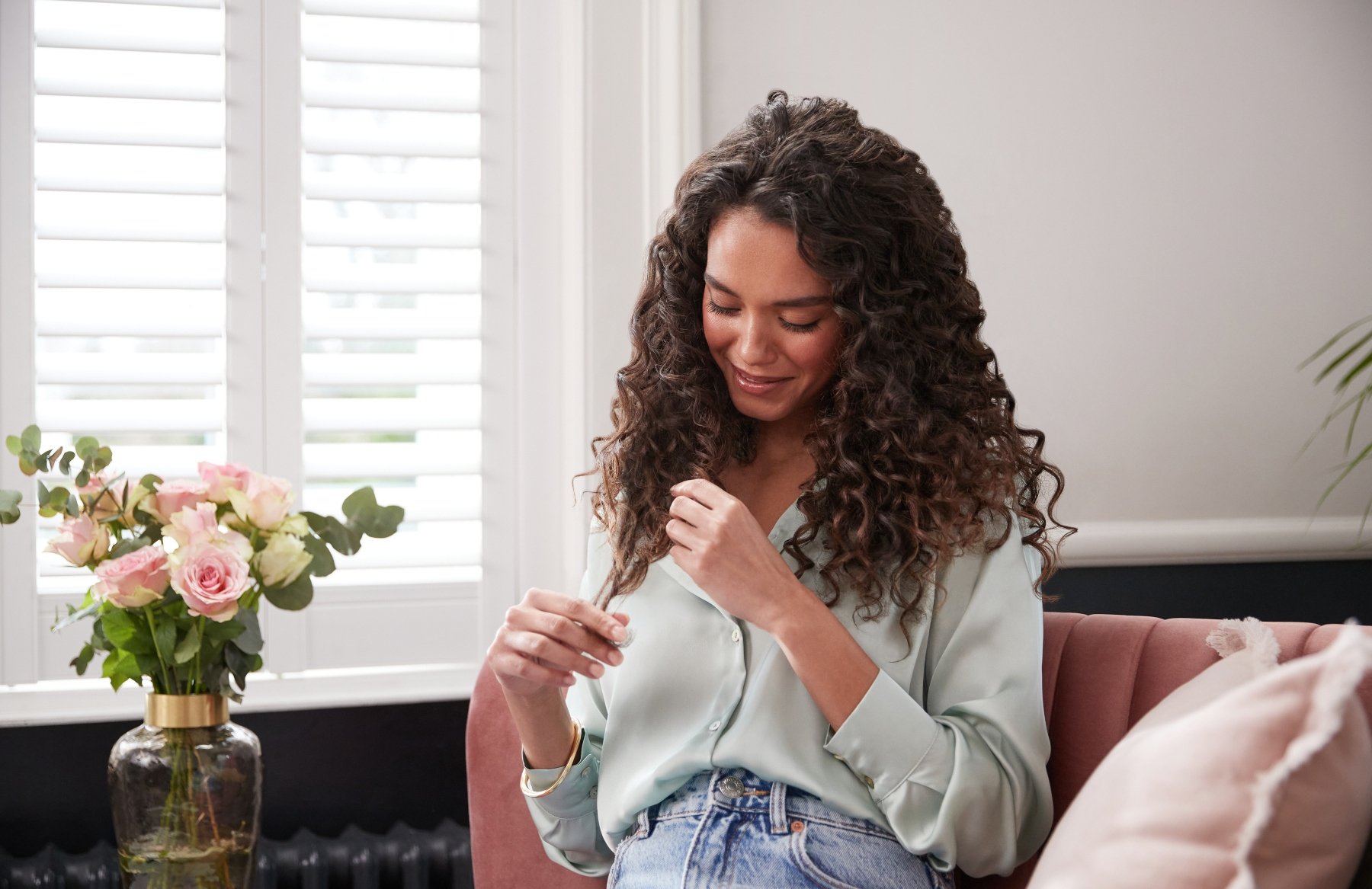 woman touching her curly hair