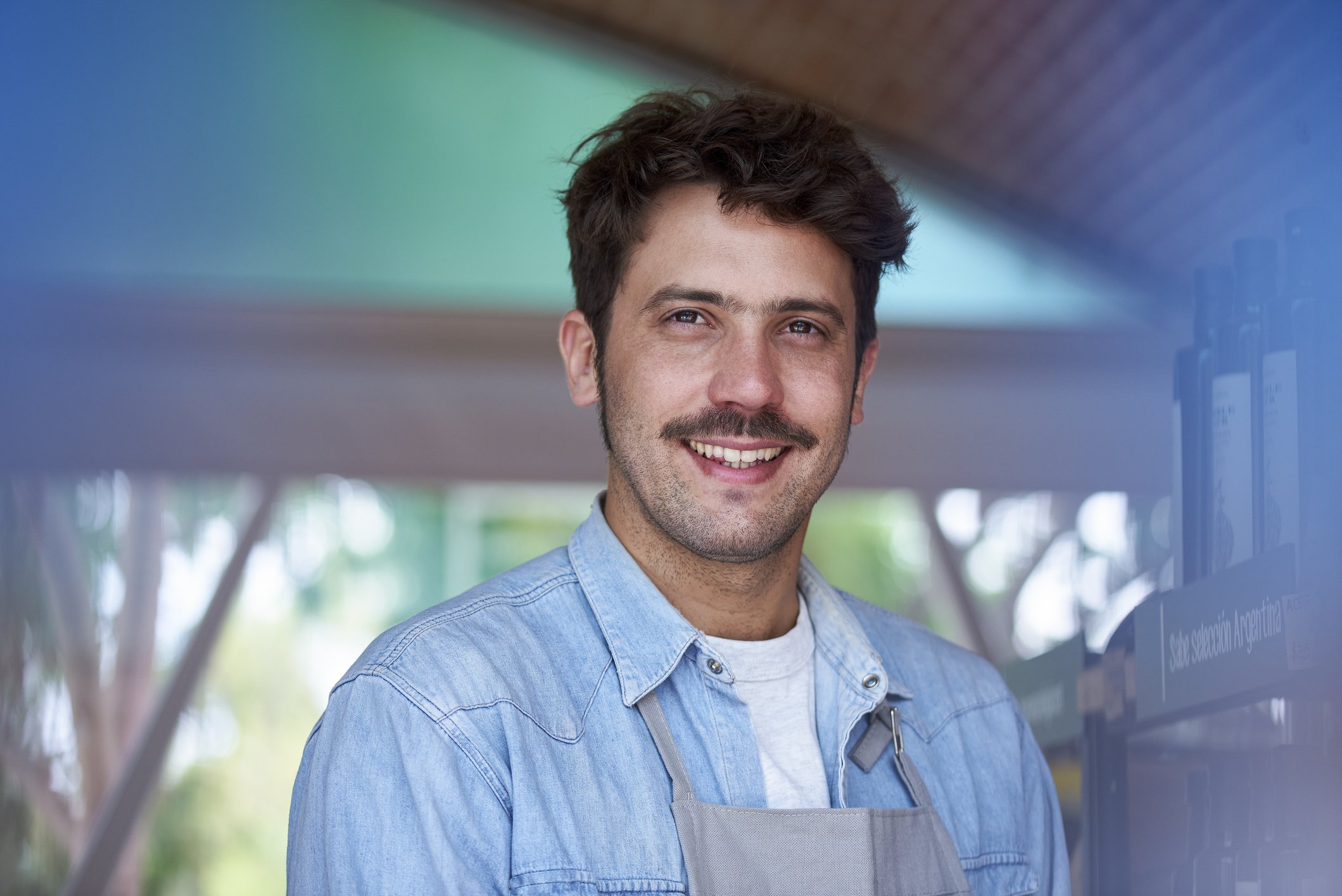 man with moustache and stubble beard smiling 
