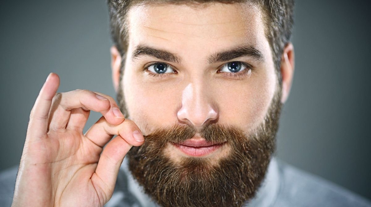 man trimming moustache
