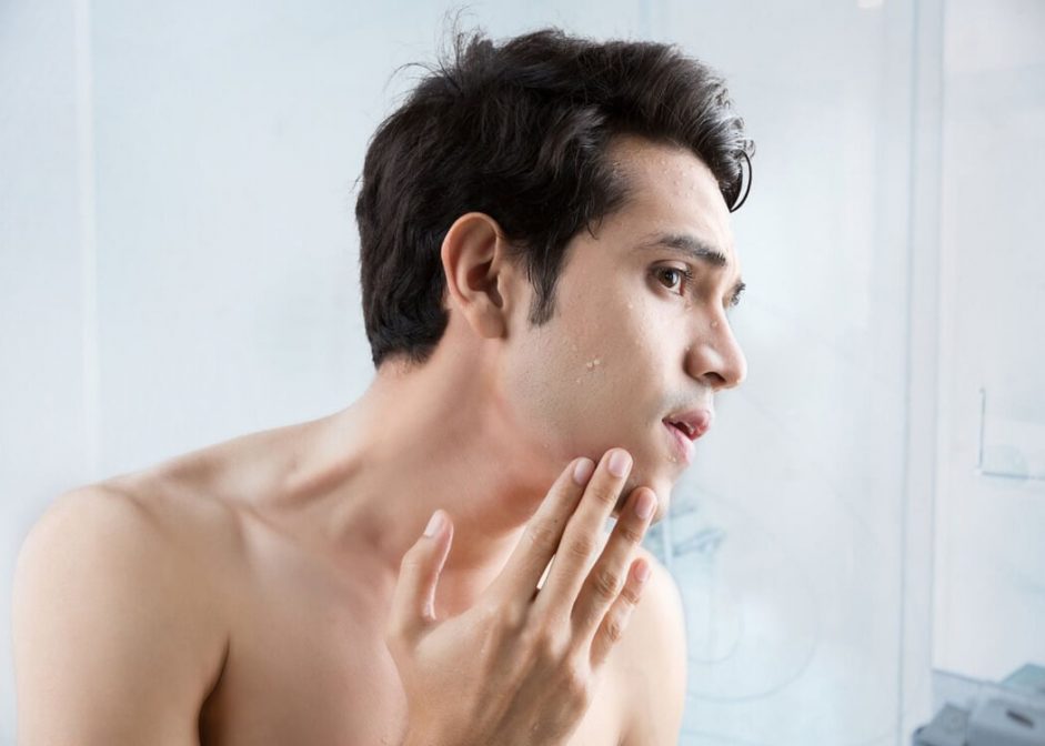 man checking for dry skin after shaving