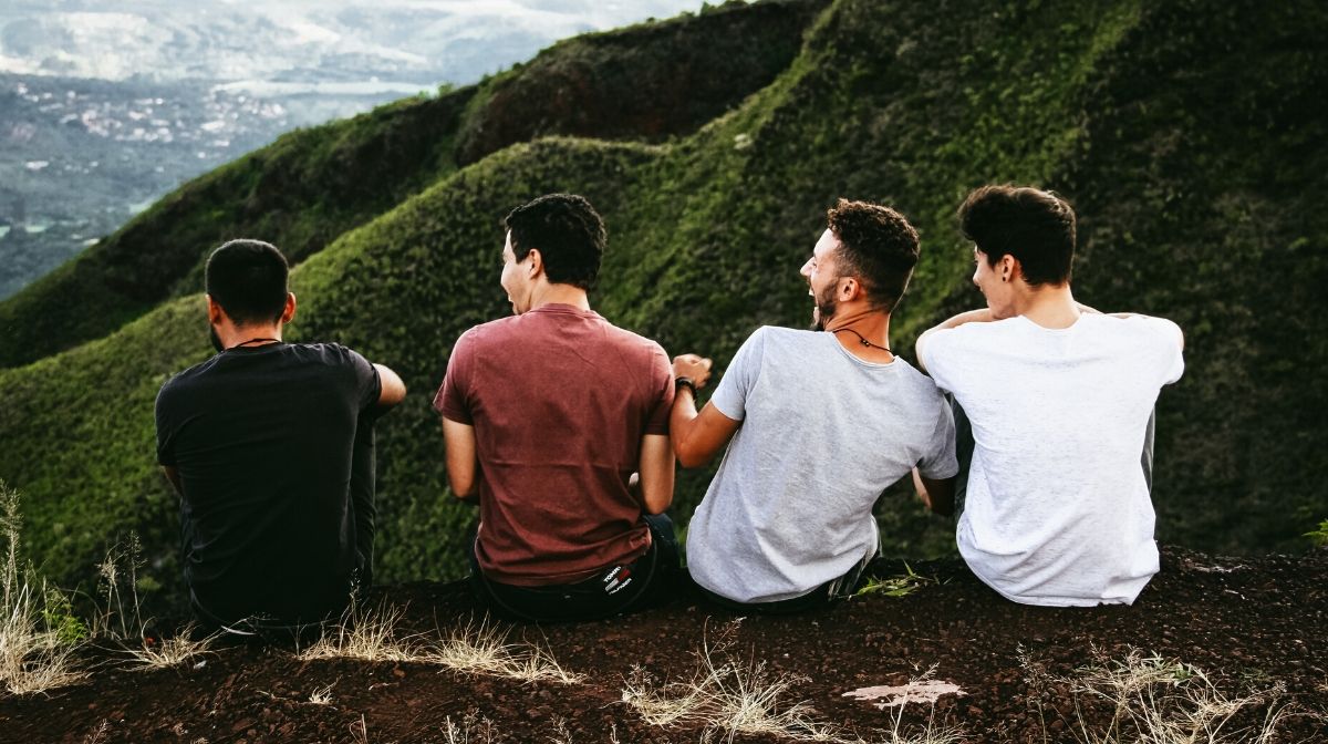 Male friends taking time to talk on an outdoor hike