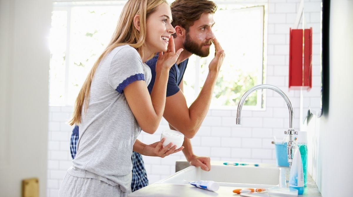 couple getting ready in the bathroom together