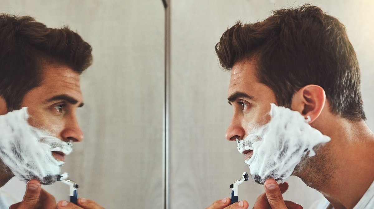 man shaving in the mirror