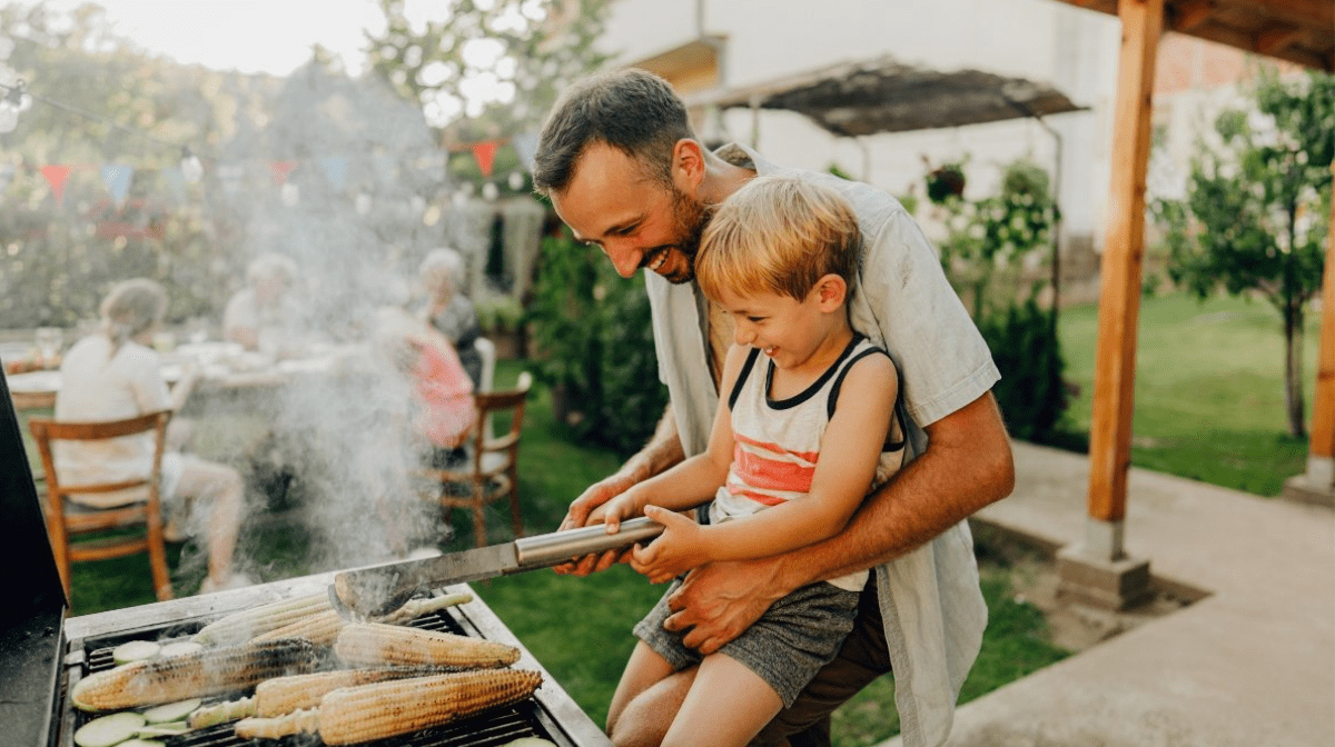 father and son looking after the barbecue