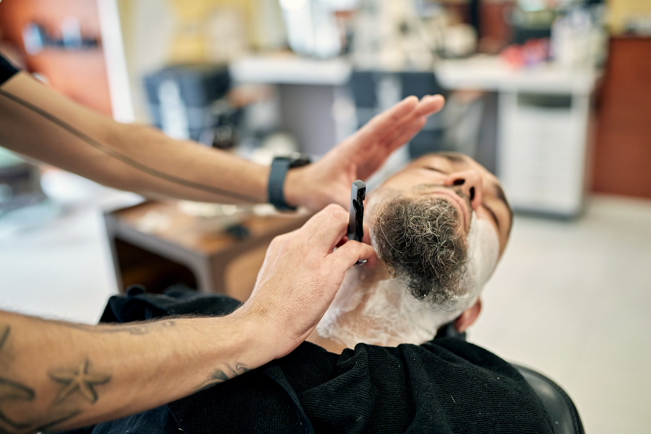 barber shaving neck to shape goatee style