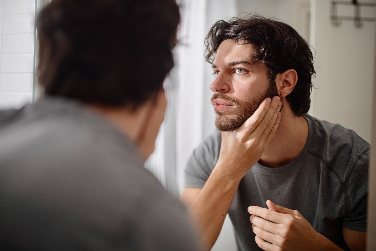 Man looking into the mirror before trimming beard with Gillette Beard trimmer | Gillette UK