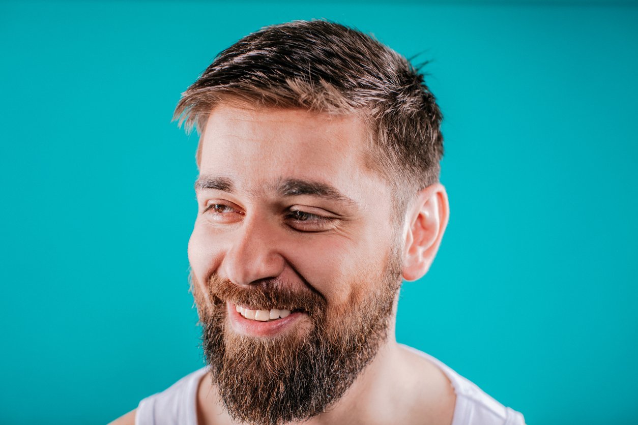 Bearded man smiling after applying King C. Gillette Beard Oil | Gillette UK