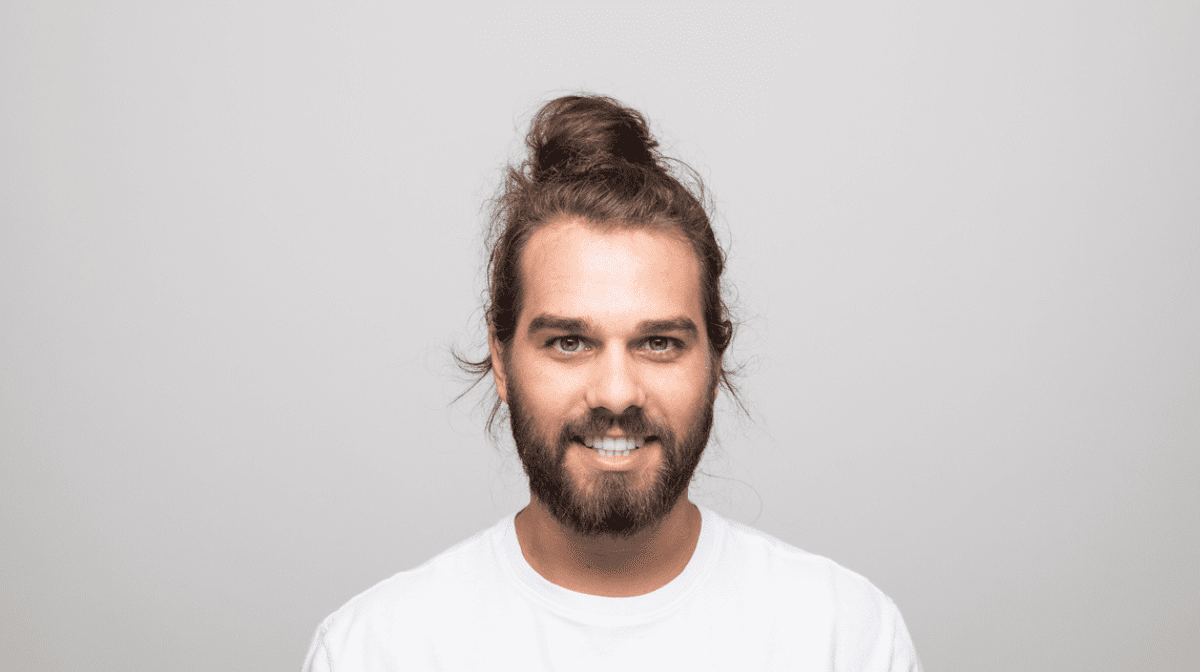 Smiling man with topknot and professional long beard style