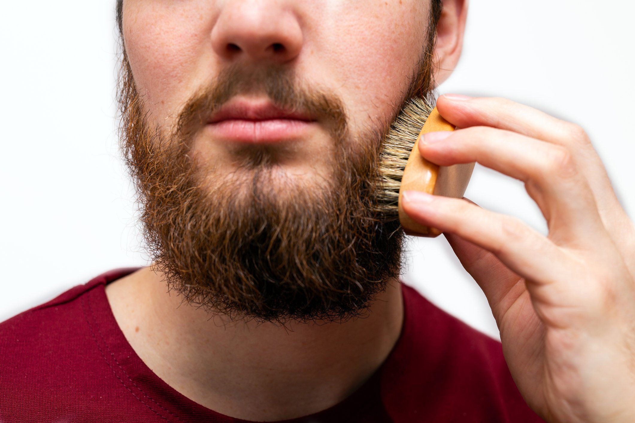 Man using beard brush on long beard style 