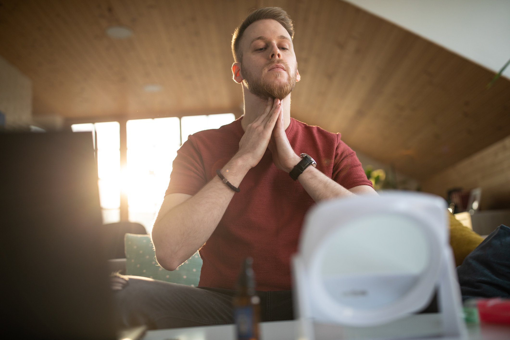 Man applying beard oil to neck to condition growth