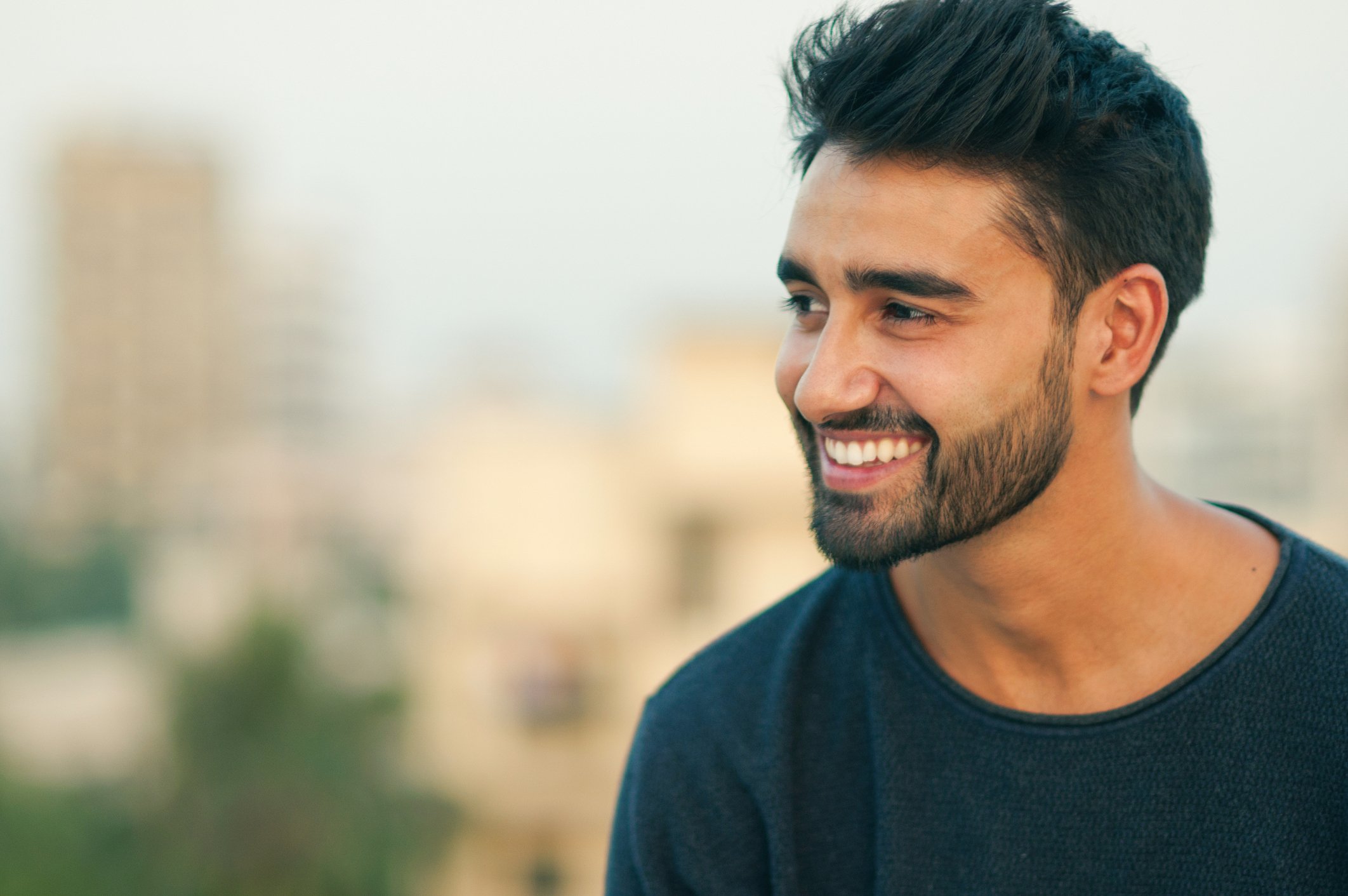 Smiling Asian man with short defined beard 
