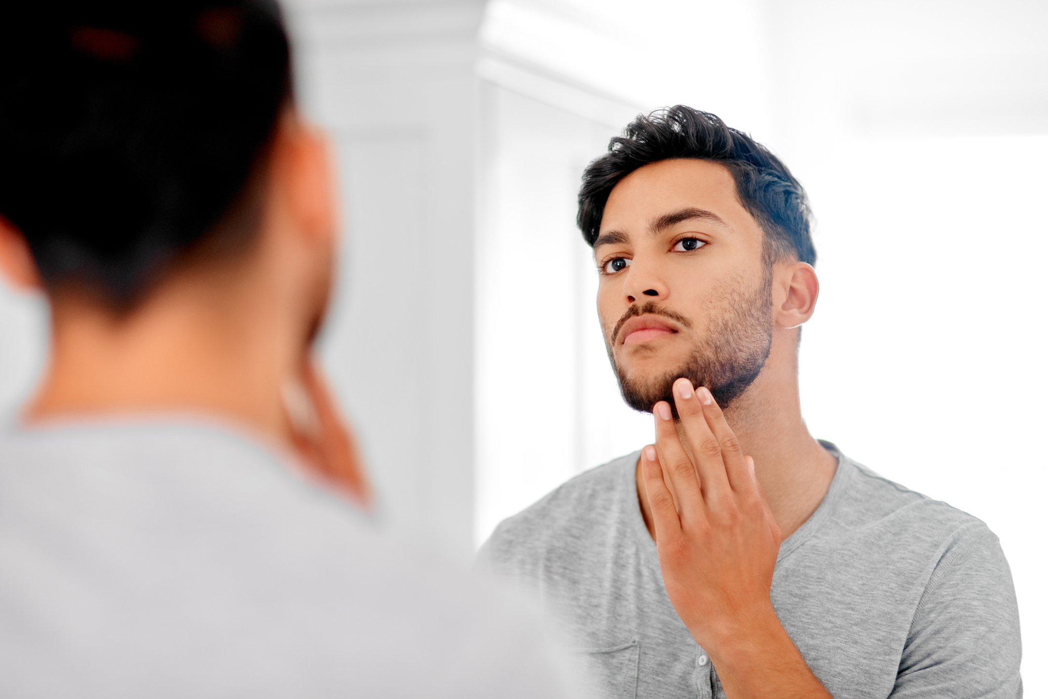 Man applies the Gillette King C. beard balm to nourish his hair