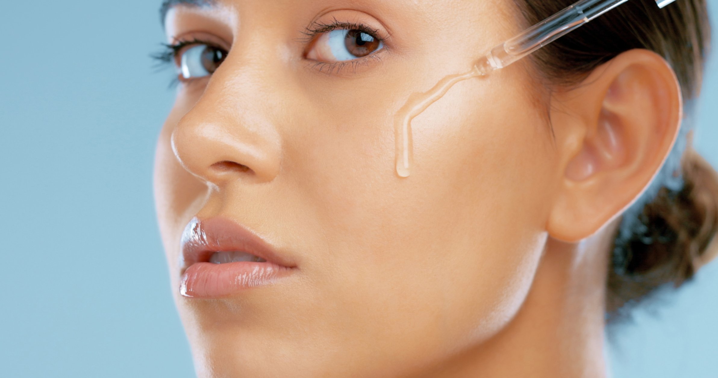 Woman applying hydrating facial serum for post-dermaplaning care | Venus UK