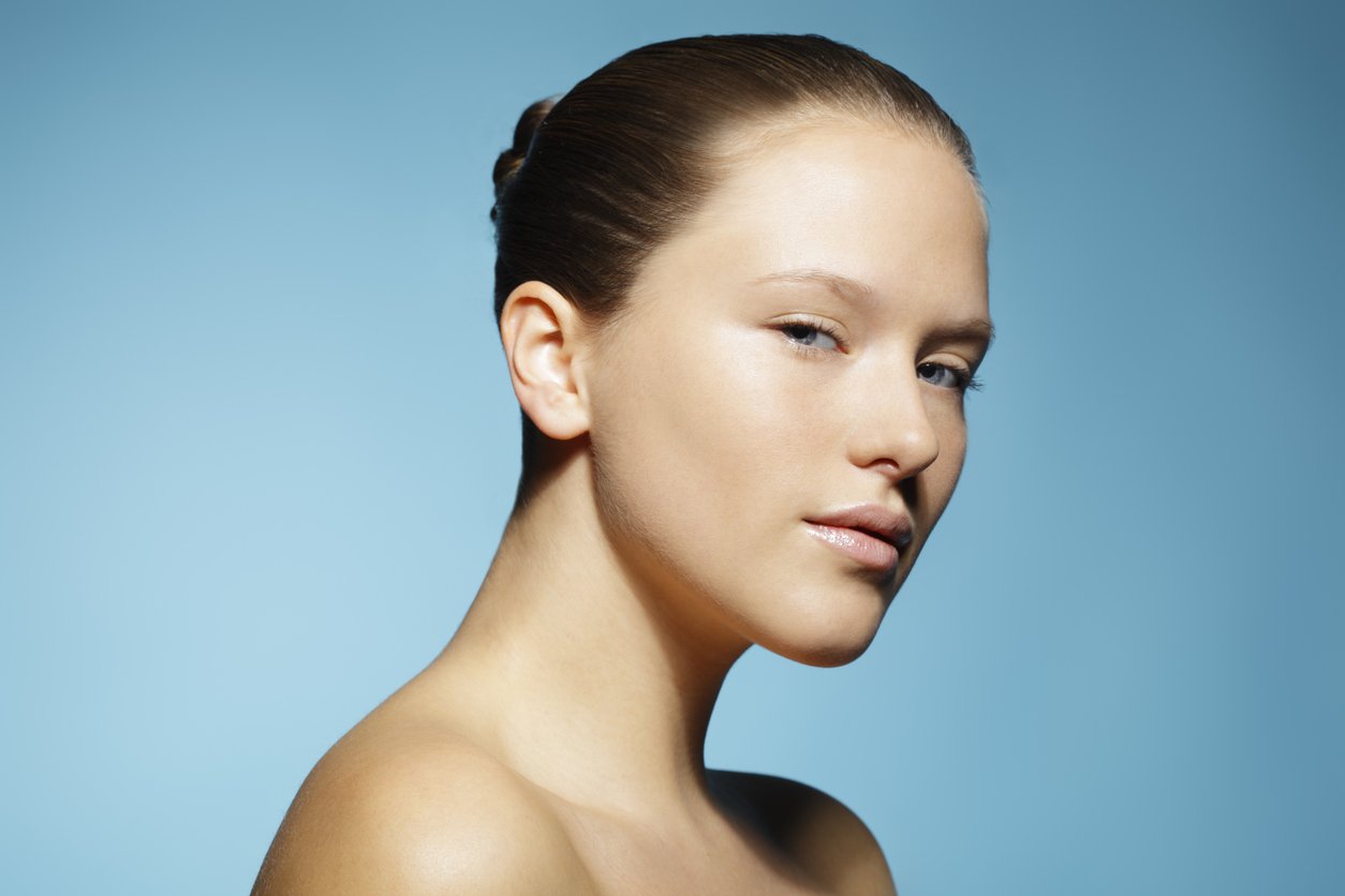 Portrait of woman with clear skin on a blue background  | Venus UK