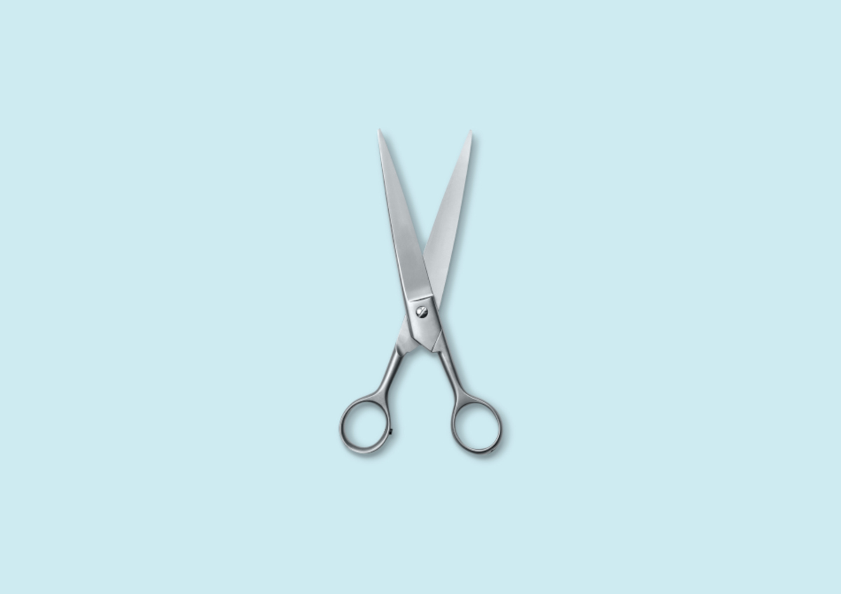 A pair of metal scissors against a pale blue background | Venus UK