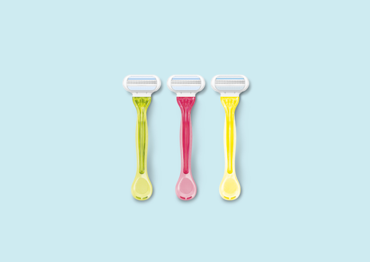 Green, pink and yellow Venus razors against a pale blue background | Venus UK