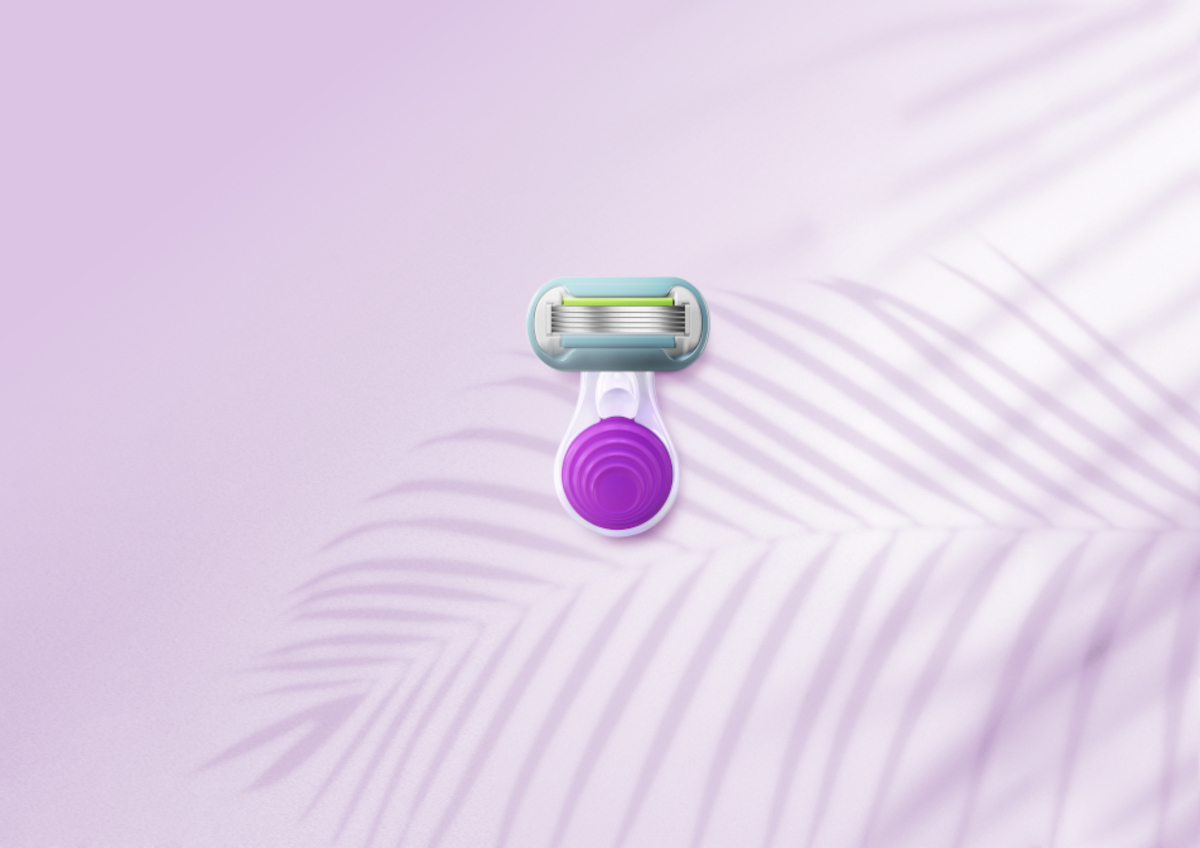 A Venus travel razor on a purple background with palm leaf shadows | Venus UK