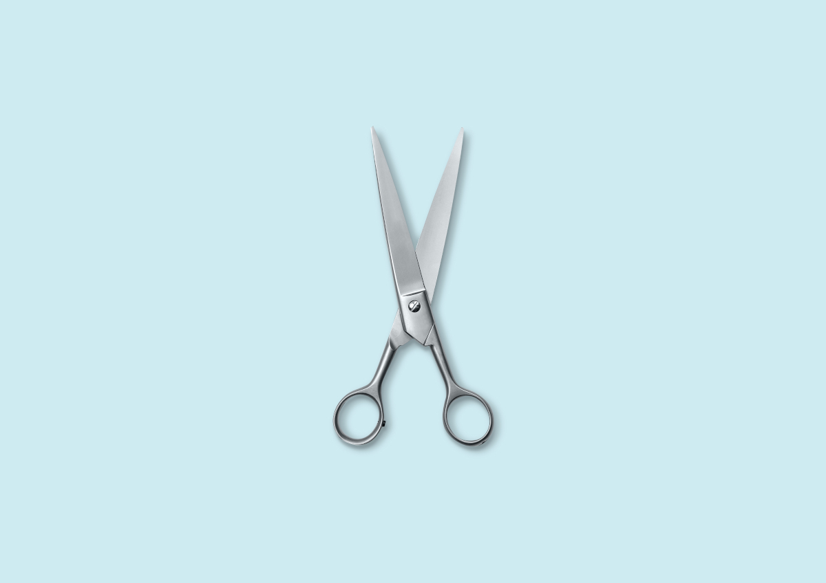 A pair of metal scissors against a pale blue background | Venus UK