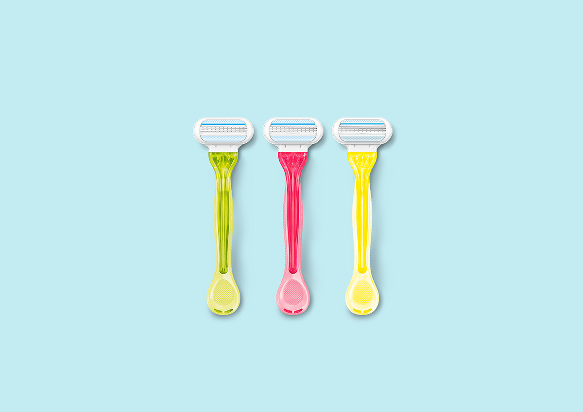 Green, pink and yellow Venus razors against a pale blue background | Venus UK
